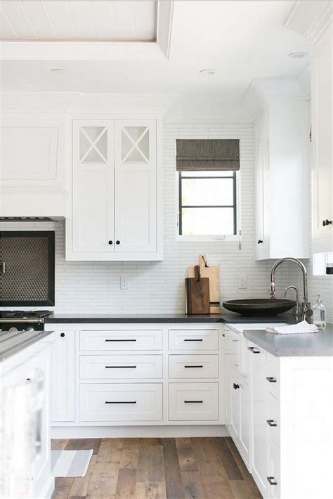 Black kitchen cabinets are a less complex color palette instead opting for monochrome style with splashes of grey to soften the contrast. black hardware // | Kitchen door handles, White kitchen ...