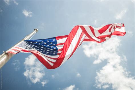 American Flag Against A Blue Sky By Stocksy Contributor Skc Stocksy