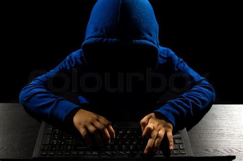 Faceless Hacker With Laptop In Black Isolated Background Stock Photo