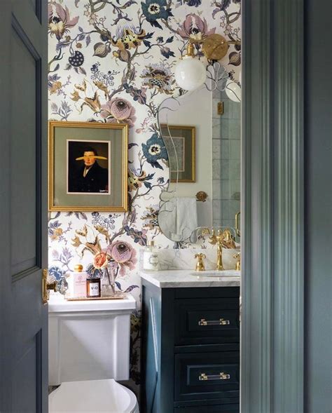 Bathroom With Floral Wallpaper And Blue Cabinets By Alisa Bovino Nj