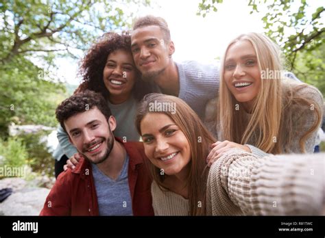 Multi Ethnic Group Of Five Young Adult Friends Pose To Camera While Taking A Selfie During A