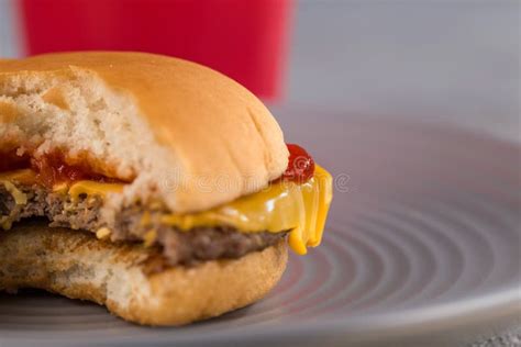 Fast Food With Delicious Cheeseburger On The Background Of A Red Cup