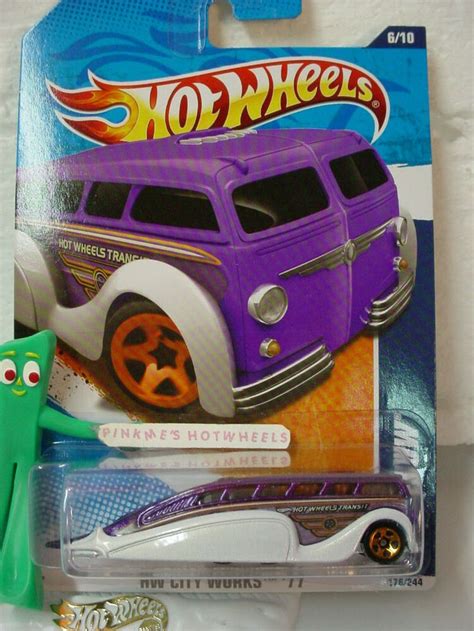 a hot wheels vehicle with orange rims on it s front and purple body