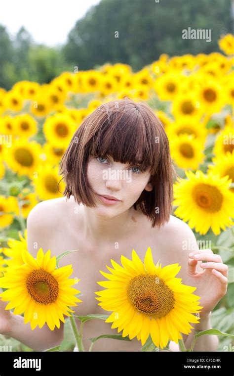 Female With Short Fringed Brunette Hair Standing Nude In The Sunflower