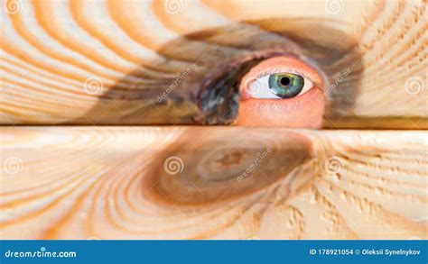 Male Person Hide Behind A Wooden Wall An Eye Looks Through A Gap In