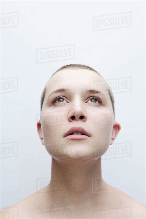 Woman With Shaved Head Looking Up Stock Photo Dissolve