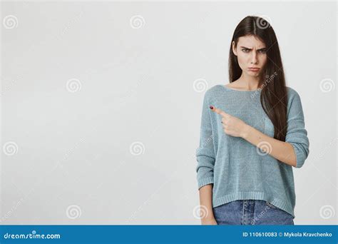 Studio Portrait Of Smart And Beautiful Trendy Girl Standing With