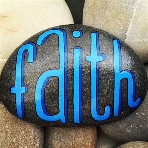 A Rock With The Word Faith Painted On It Surrounded By Large Rocks And