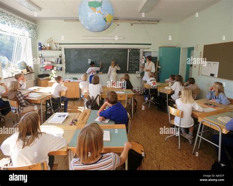 Elementary School Children At Desks And Blackboard In Swedish Stock
