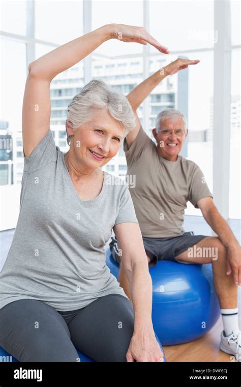 Senior Couple Doing Stretching Exercises On Fitness Balls Stock Photo