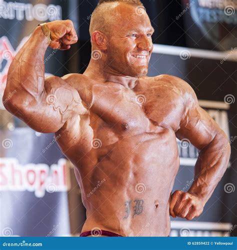 Male Bodybuilder Shows His Big Biceps On Stage Editorial Photography