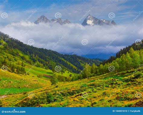 Beautiful Green Mountain Valley And Mount Peak In A Dense Clouds Stock