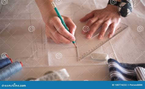 Female Fashion Designer Working With Pattern Cutting At Studio Stock