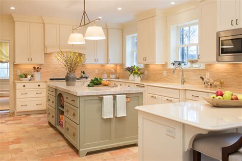 Gray wash stained wood & i don't care how many gold lights illuminate a black shaker kitchen peninsula accented with brass hardware and a white quartz. Green island and white wall mouser kitchen cabinets with ...