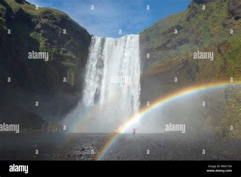 Person In The Rainbow Beneath 60m High Skogafoss Waterfall Skogar
