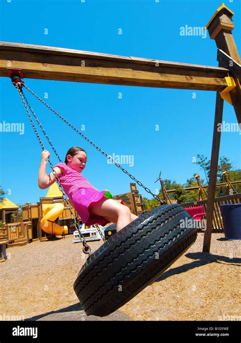 Young Girl On Tire Swing Stock Photo Alamy