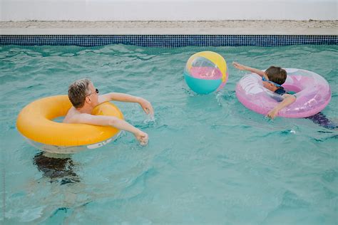 Dad And Son On Matching Inflatable Pool Rings Have Fun Del