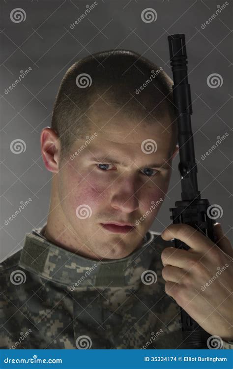 Young Soldier Looking Sad And Leaning On Assault Rifle Stock Images