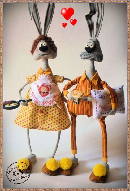 Two Stuffed Rabbits Dressed In Clothes And Shoes With Hearts Above Their Heads One Holding A