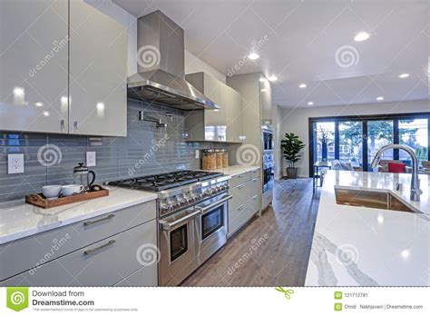 Its details are manifested in the beautiful finish of the solid wood. Sleek Modern Kitchen Design With An Island Stock Image - Image of hood, design: 121712781