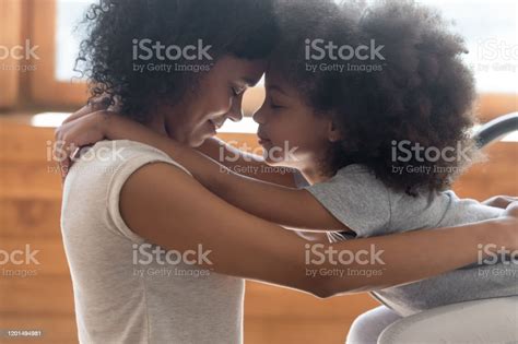 Loving Biracial Mom And Daughter Touch Foreheads Making Peace Stock