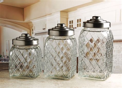 First, straighten up the vanity with sink accessories: Circleware 3-Pc. Embossed Canister Set