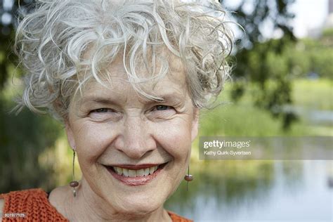 Smiling Happy 66 Year Old Senior Woman By Pond Photo Getty Images
