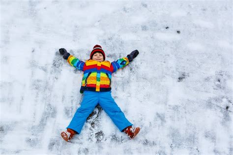 Little Kid Boy Making Snow Angel In Winter Stock Image Image Of Cold