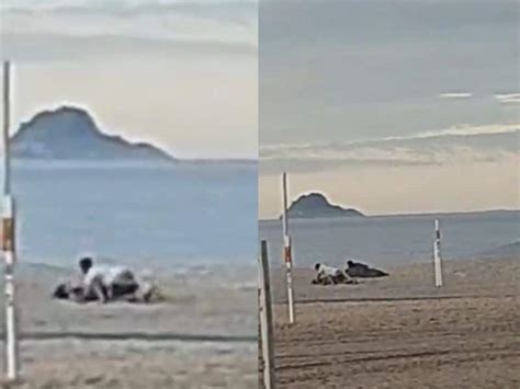 Vídeo Deitadinha Esperando Rola Casal Transa Na Praia Enquanto Morador De Rua Assiste Tudo