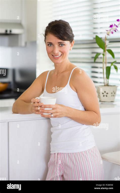 Caucasian Woman Drinking Coffee In Kitchen Stock Photo Alamy
