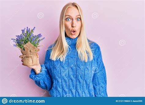 Young Blonde Girl Holding Lavender Pot Scared And Amazed With Open Mouth For Surprise Disbelief