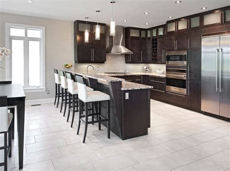 There are many different materials used to manufacture kitchen cabinets, the price range and quality that you sate for your kitchen will help you determine which material serve your needs the most, materials include wood, metals and laminate. KITCHEN // Raised peninsula overhang with a different counter top material | Dark kitchen ...