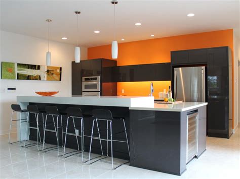 A single wall kitchen with stainless steel appliances and stainless steel accents a hood and burnt orange cabinets. Pastel Tone - Good Color to Paint a kitchen - HomesFeed