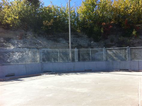 Chain Link Fence On Top Of Concrete Wall Installed By Titan Fence