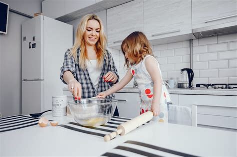 Una Hermosa Joven Madre Con Su Pequeña Hija Está Cocinando En La Cocina