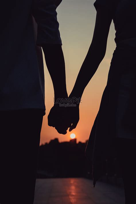Couple In The Sunset Holding Hands Silhouette Picture And Hd Photos