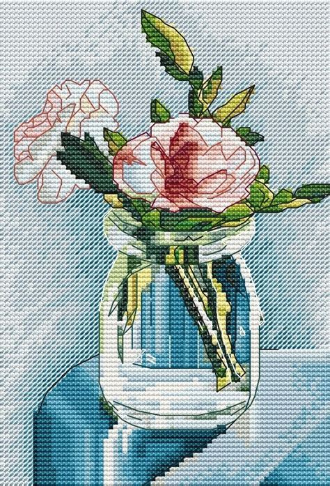 A Painting Of Flowers In A Glass Vase On A Blue Tablecloth With White