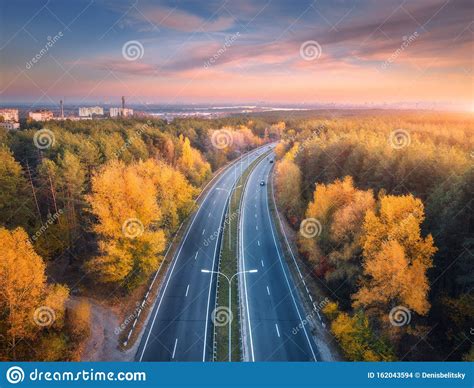 Aerial View Of Asphalt Road In Beautiful Autumn Forest At Sunset Stock
