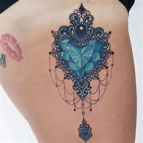A Woman S Thigh With An Intricate Tattoo Design On The Back Of Her Leg