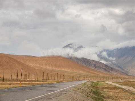 Empty Highway Passing Through Stormy Mountain Landscape Stock Photo