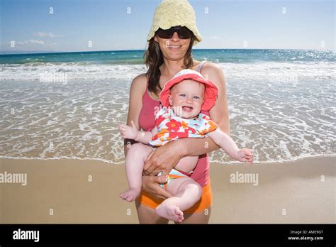 Mother Holding Her Baby On The Beach Stock Photo Alamy