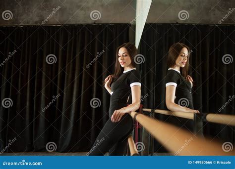 Young Woman Dancer Warming Up Near The Ballet Barre Stock Photo Image