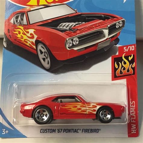 A Red Hot Wheels Car With Flames On The Hood