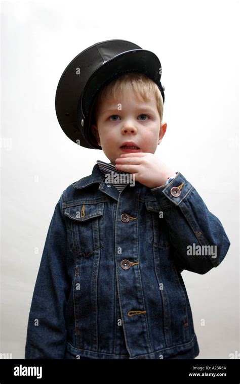 4 Year Old Boy Wearing Peaked Salvation Army Hat Looking Pensive Stock