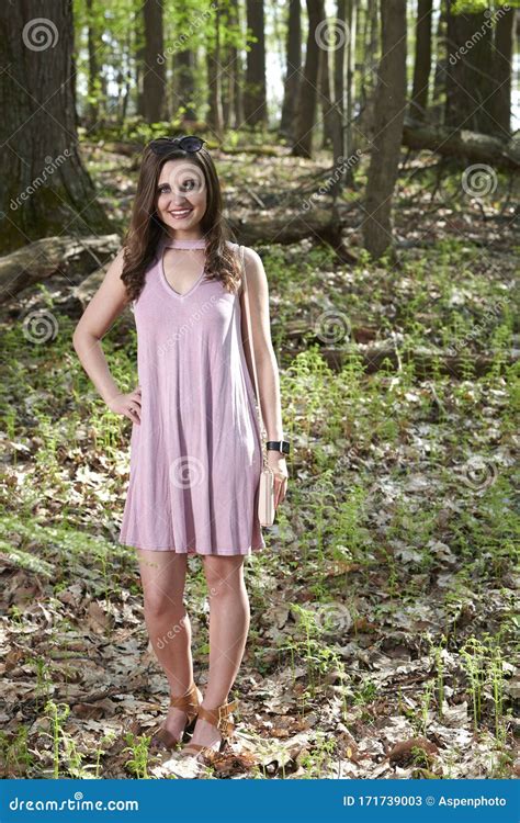 Stunning Young Woman In Pink Cocktail Dress Poses In Forest Stock Image