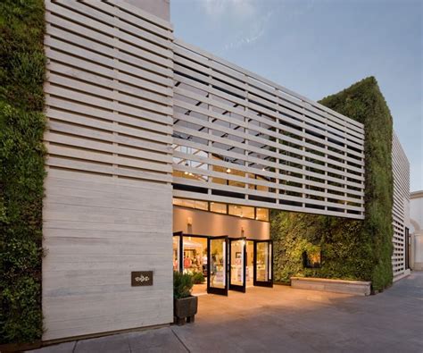 The Vertical Green Wall Folds In The Wood Slats Create A Screening
