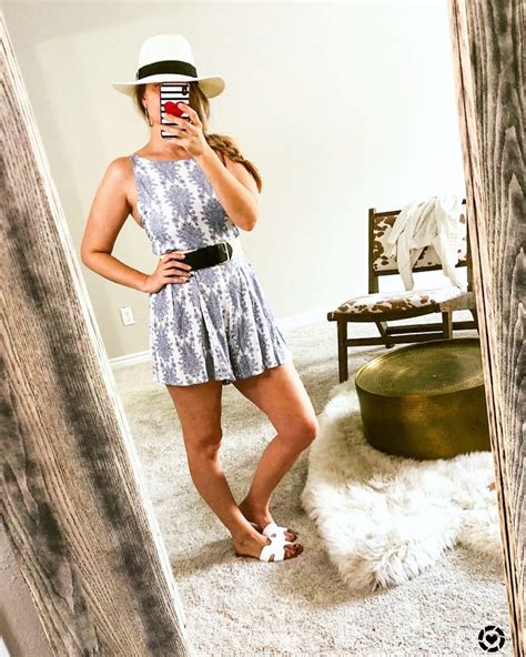 favorite romper for italy vacay styled with a waist belt and straw hat summer romper straw hat