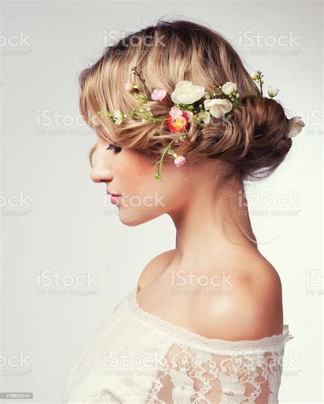 Portrait Of Beautiful Blonde Woman With Flowers In Her Hair Stock Photo