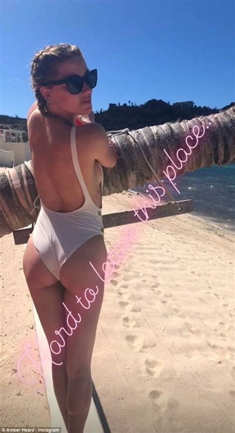 Amber Heard Shows Off Her Derriere In A Skimpy White Swimsuit While Vacationing In A Tropical