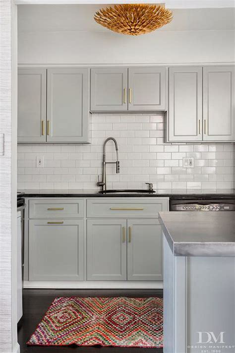Accent colors include a deep brown range hood, black kitchen island, and deep grey marble countertops. 80+ Cool Kitchen Cabinet Paint Color Ideas - Noted List